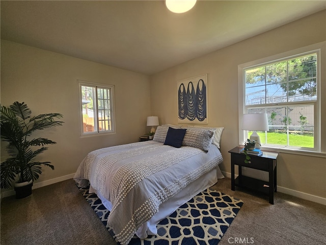 bedroom featuring dark colored carpet