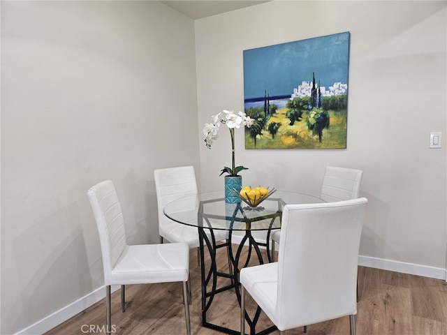 dining area with hardwood / wood-style floors