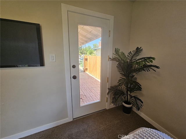 doorway to outside featuring carpet