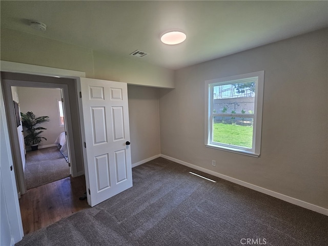 unfurnished bedroom with dark hardwood / wood-style flooring