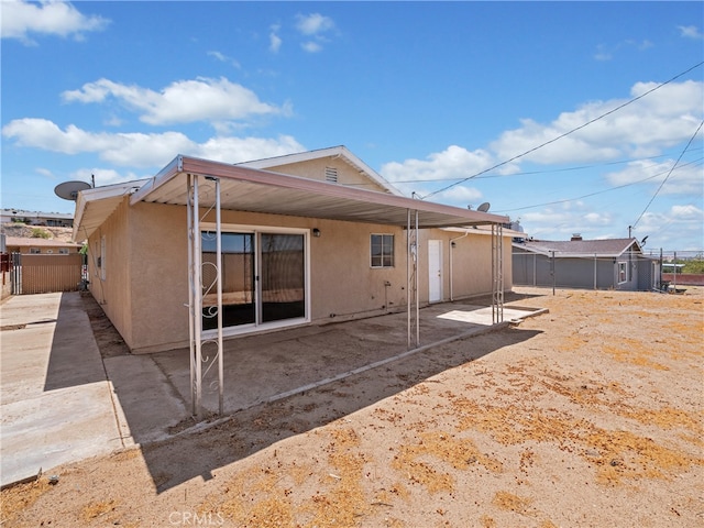 back of property with a patio