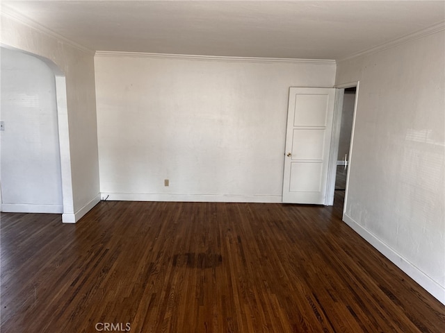 empty room featuring crown molding and dark wood-type flooring