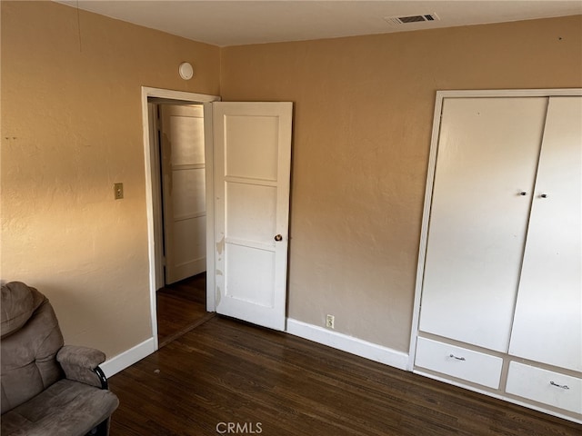 unfurnished room with dark wood-type flooring