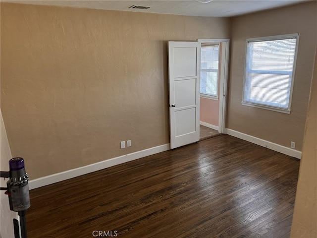 empty room featuring dark hardwood / wood-style flooring