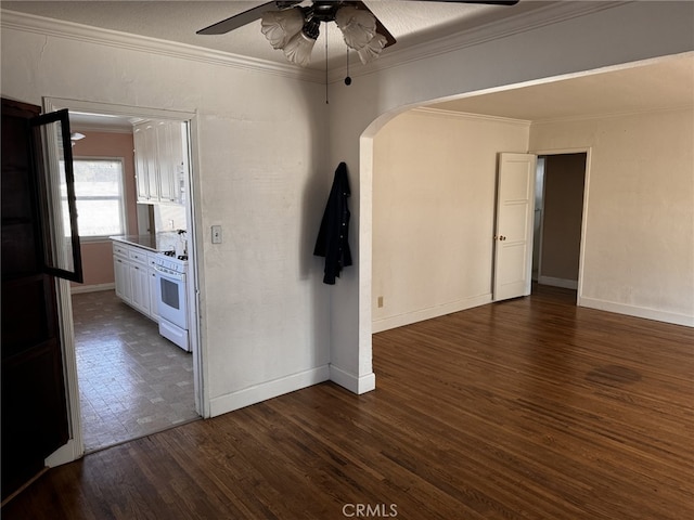 empty room featuring ornamental molding, dark hardwood / wood-style flooring, and ceiling fan