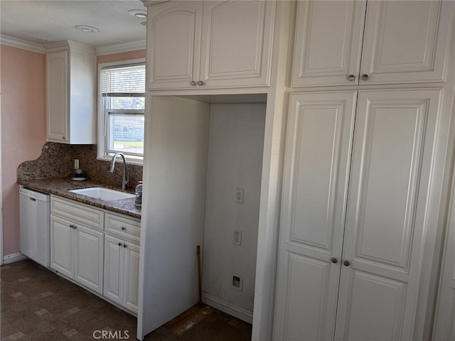 kitchen featuring sink, white cabinetry, dishwasher, dark stone counters, and crown molding