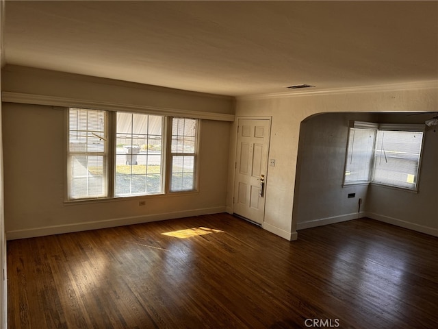 unfurnished room featuring crown molding and dark hardwood / wood-style flooring