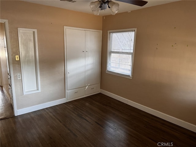 unfurnished bedroom with dark hardwood / wood-style flooring and ceiling fan