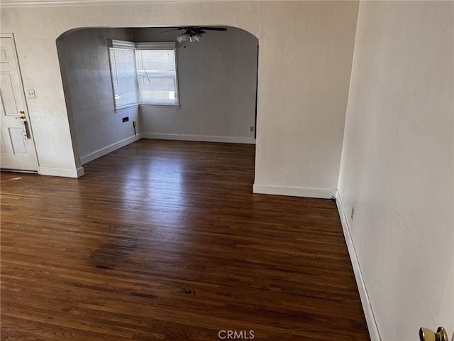 empty room featuring ceiling fan and dark hardwood / wood-style flooring