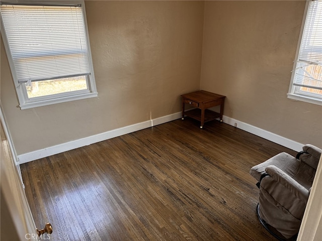 empty room with dark hardwood / wood-style flooring