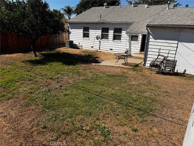 back of house with central AC, a patio area, and a yard