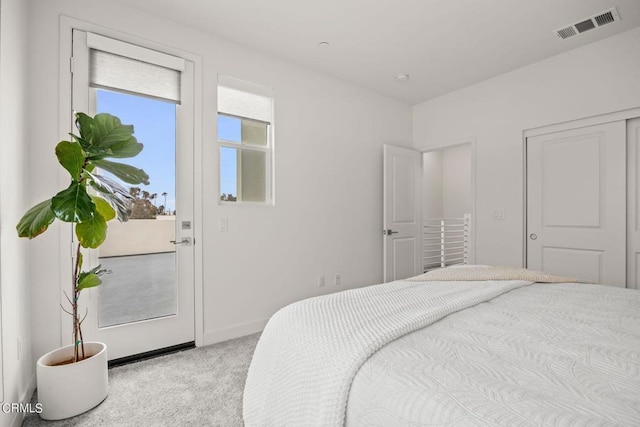bedroom featuring baseboards, visible vents, and light carpet