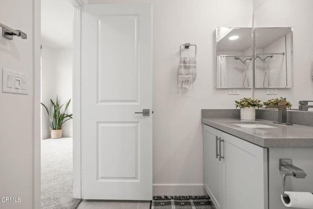 bathroom with baseboards and vanity