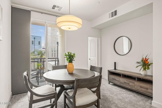 dining space featuring baseboards, carpet floors, and visible vents