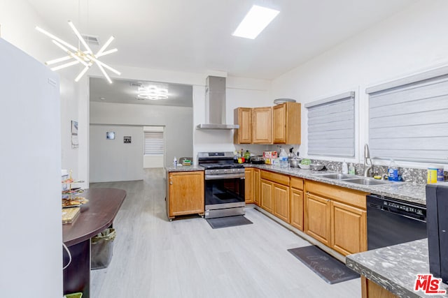 kitchen featuring dishwasher, sink, wall chimney exhaust hood, light wood-type flooring, and stainless steel range