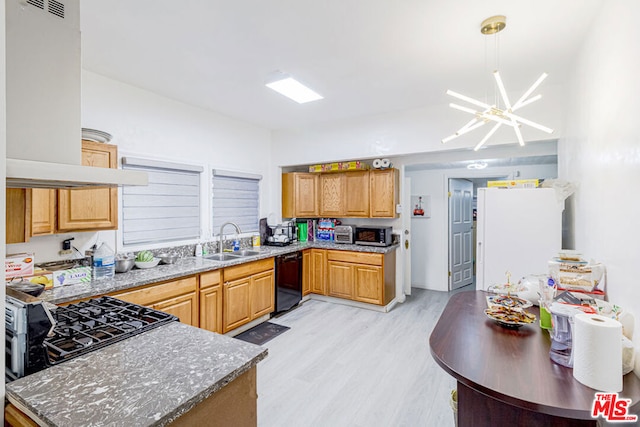 kitchen with stone countertops, sink, black dishwasher, a notable chandelier, and light hardwood / wood-style floors