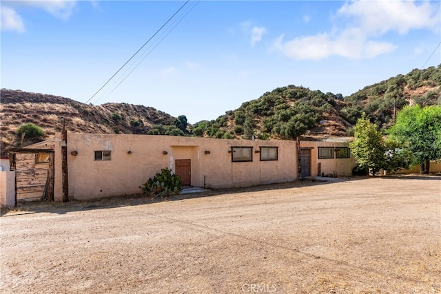 adobe home featuring a mountain view