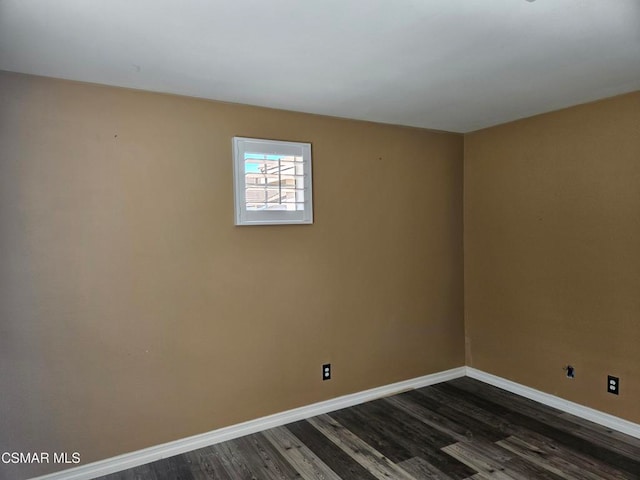 spare room featuring dark hardwood / wood-style flooring