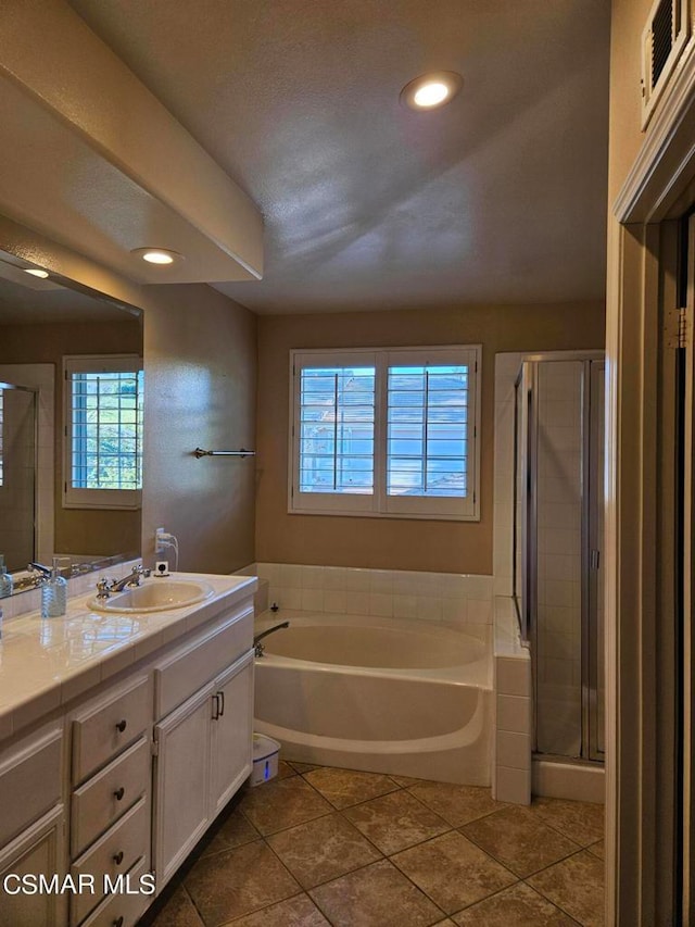 bathroom featuring a wealth of natural light, tile patterned flooring, independent shower and bath, and vanity