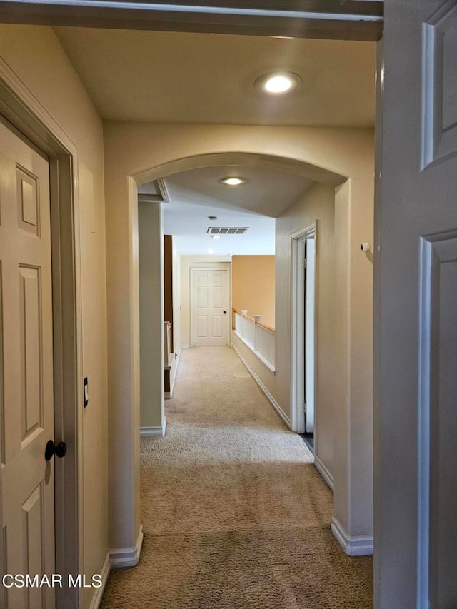 hall featuring light colored carpet