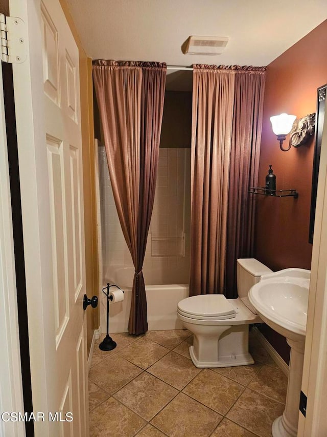 bathroom featuring shower / bath combo, tile patterned floors, and toilet