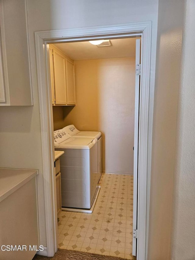 laundry area with cabinets and independent washer and dryer