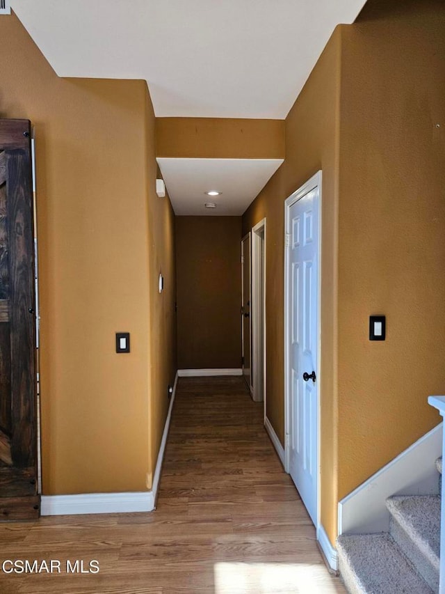 corridor with wood-type flooring