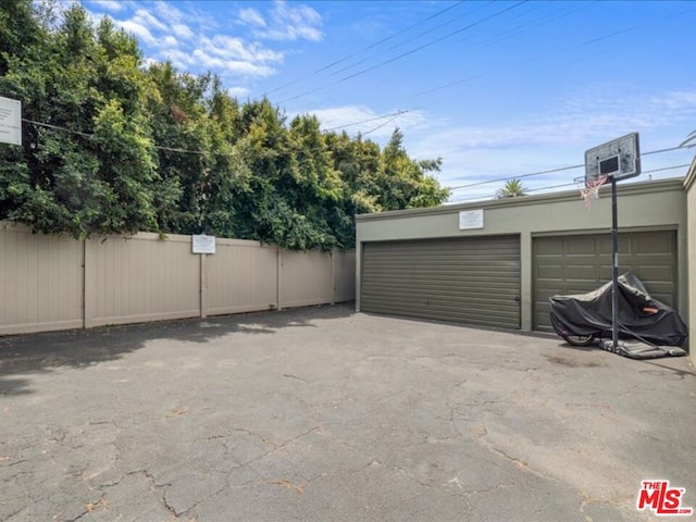 view of patio featuring a garage and an outdoor structure