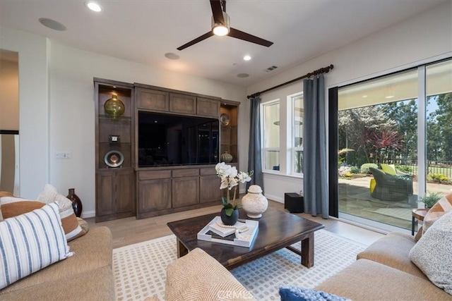 living room featuring a ceiling fan, plenty of natural light, visible vents, and recessed lighting