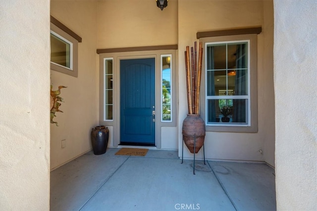 view of exterior entry with stucco siding