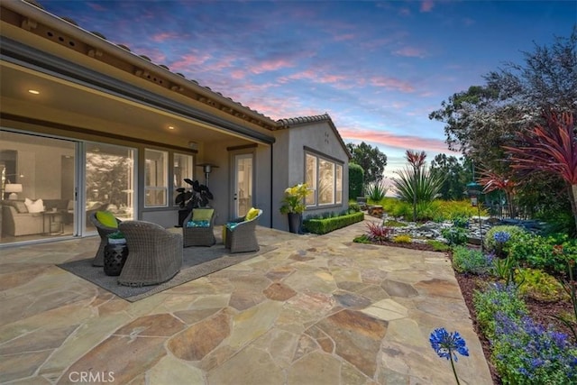 view of patio terrace at dusk