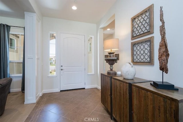 entrance foyer featuring recessed lighting, baseboards, and tile patterned floors