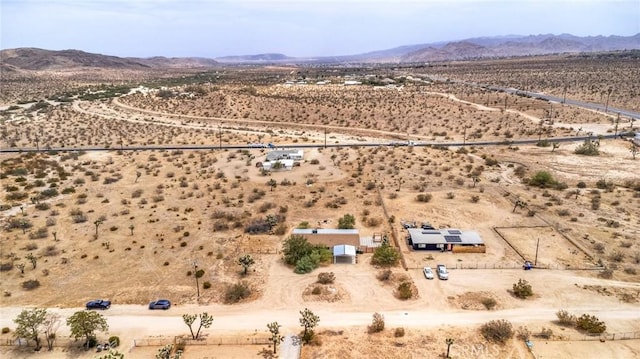 birds eye view of property featuring a mountain view, a rural view, and view of desert