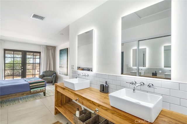 bathroom featuring vanity, backsplash, and tile patterned floors