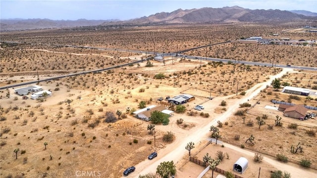bird's eye view featuring a rural view, view of desert, and a mountain view