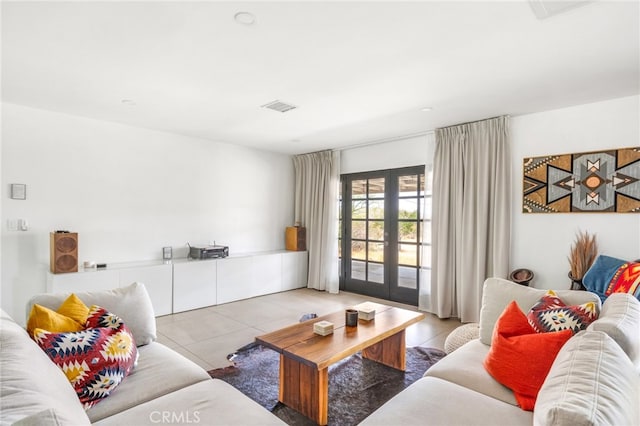 living room featuring french doors and tile patterned flooring