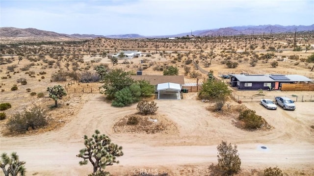 birds eye view of property featuring a mountain view, a rural view, and view of desert