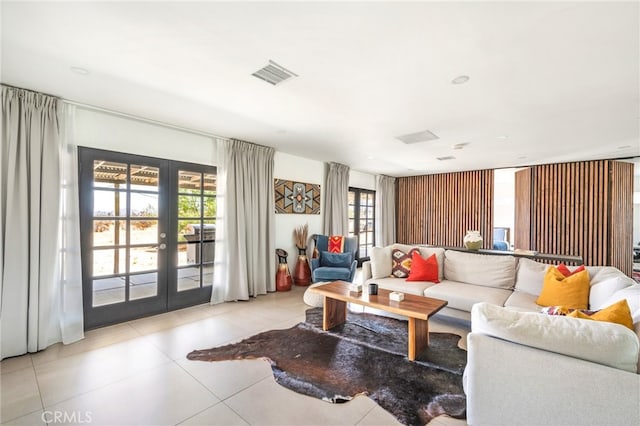 living room featuring a wealth of natural light, french doors, and light tile patterned floors