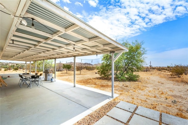 view of patio / terrace with a mountain view and area for grilling