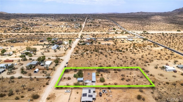 birds eye view of property featuring a mountain view