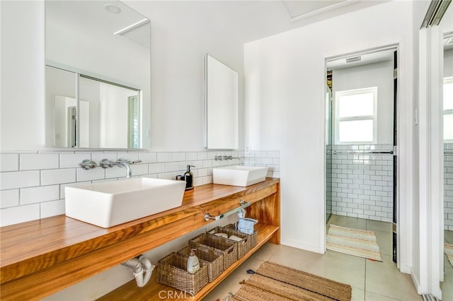 bathroom featuring vanity, tile patterned floors, walk in shower, and decorative backsplash