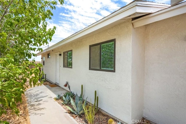 view of side of property with stucco siding