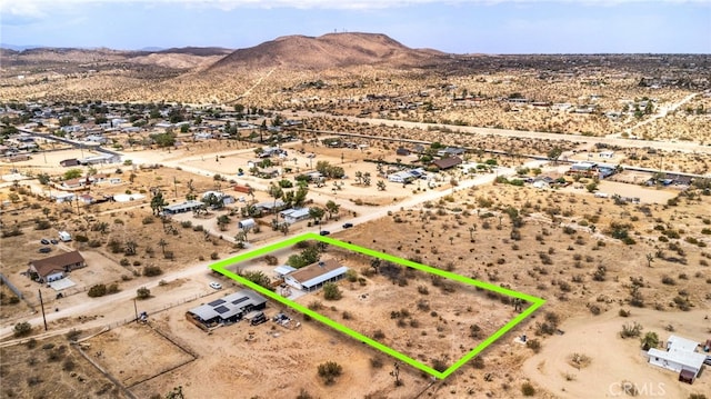 birds eye view of property featuring a mountain view