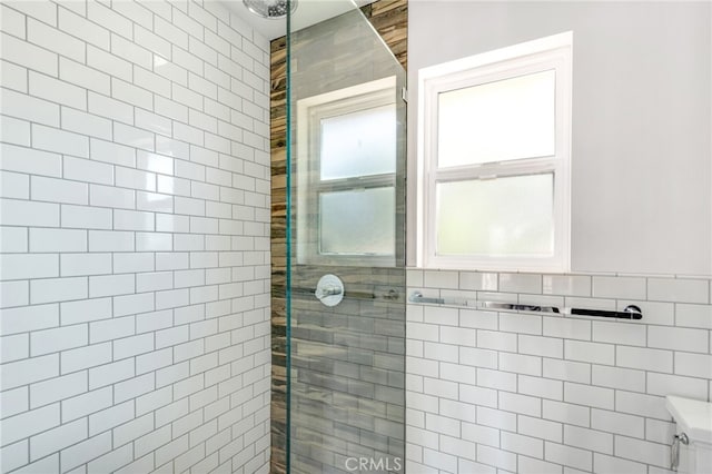 bathroom with tile walls and a tile shower