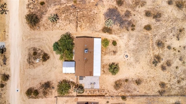 drone / aerial view featuring view of desert and a rural view