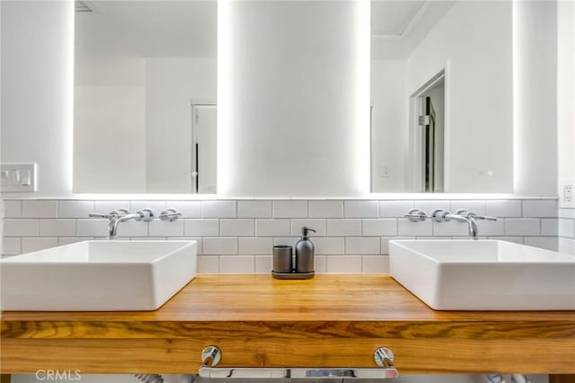 bathroom with vanity and decorative backsplash