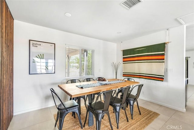 tiled dining space featuring baseboards and visible vents