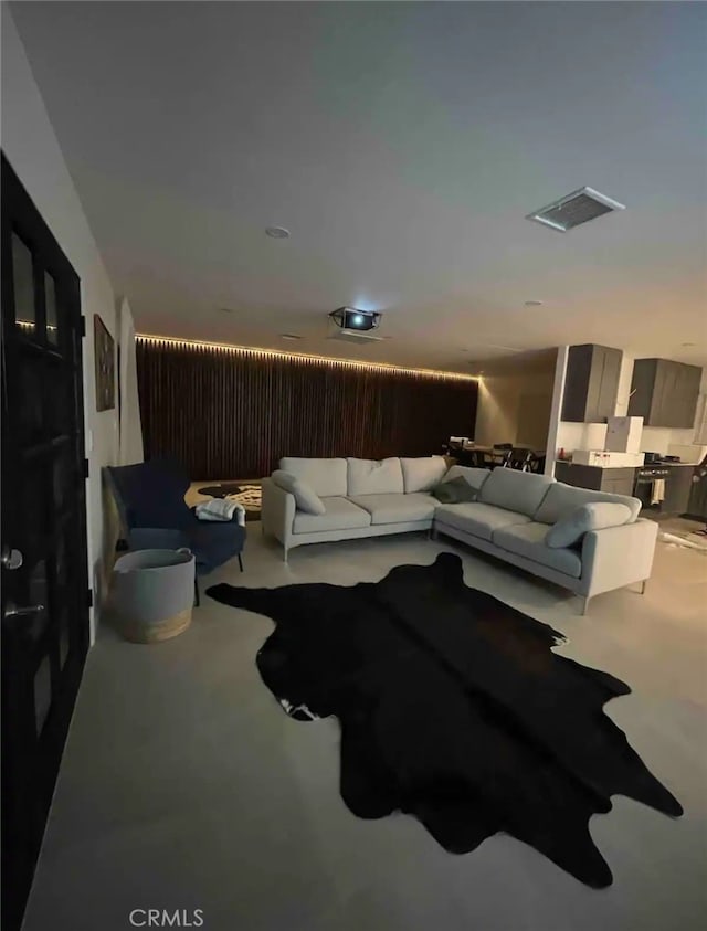 carpeted home theater room featuring visible vents