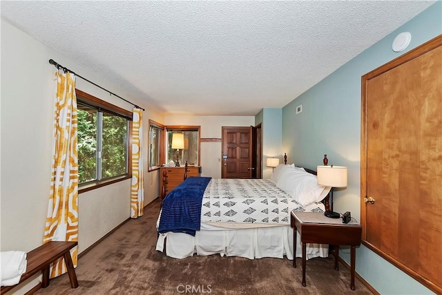 carpeted bedroom with a textured ceiling