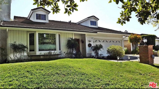 view of front of house featuring a garage and a front lawn